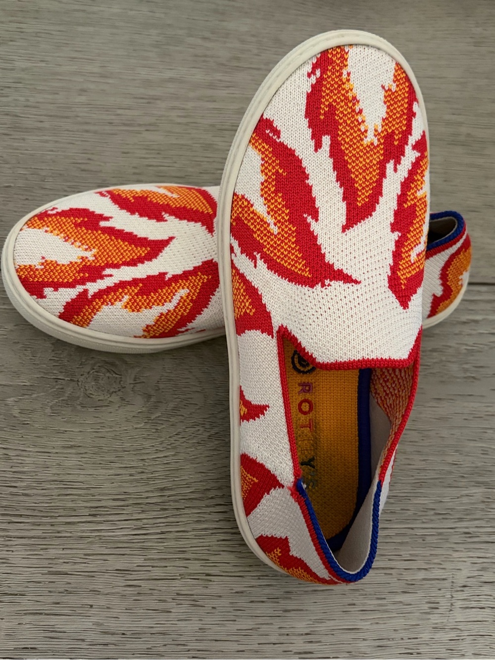 Rothy's White Slip-On Sneakers with Red & Blue Flame Accents